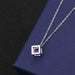 Cube pendant with purple diamond on cross chain